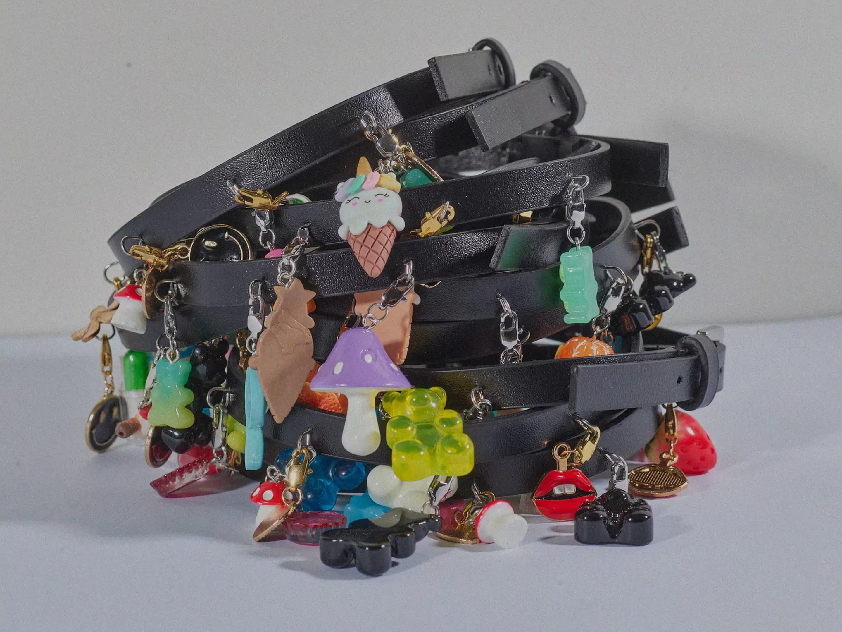 Pile of black leather chokers with colorful candy-like charms