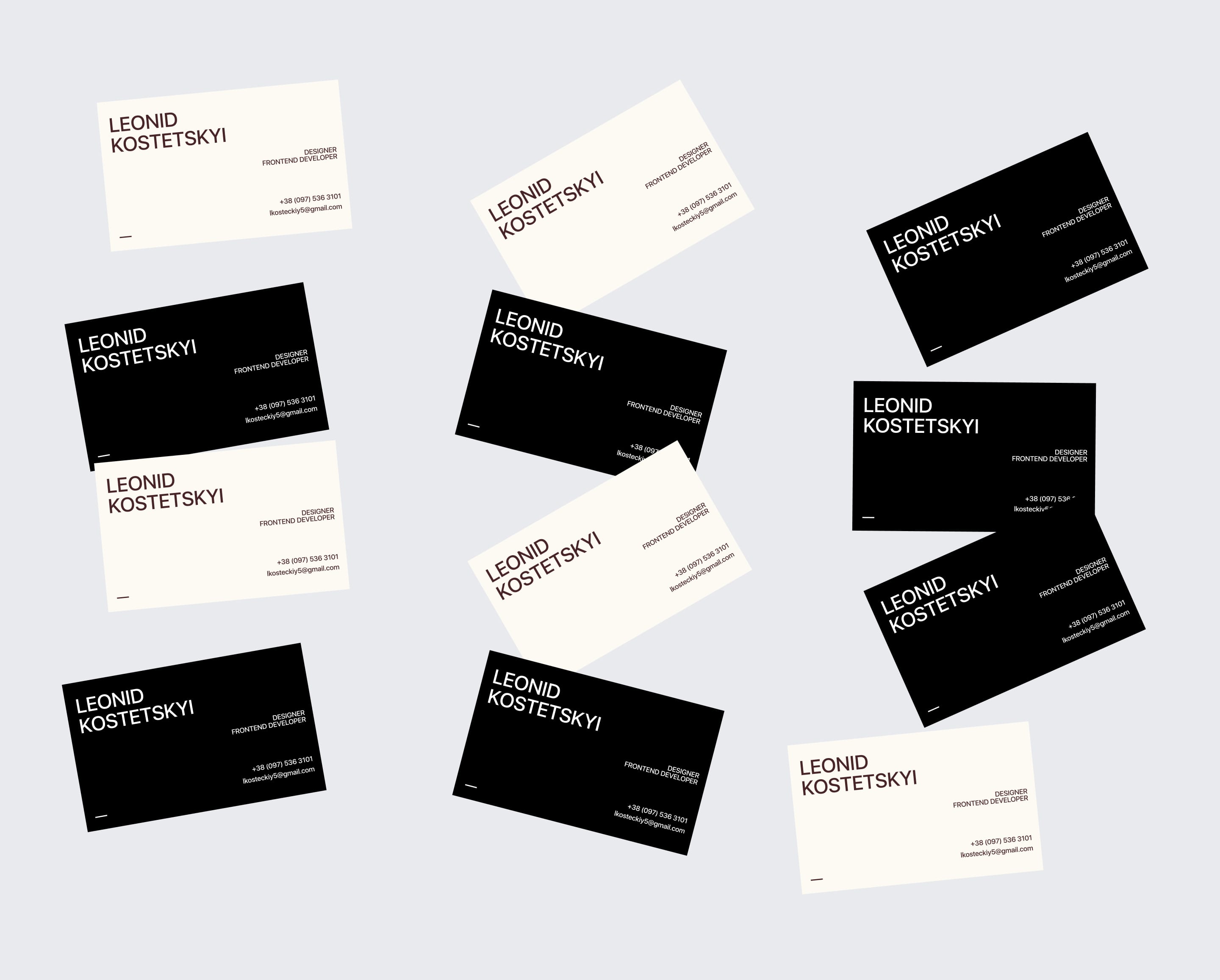 Scattered black and off-white business cards with the Leonid Kostetskyi wordmark
