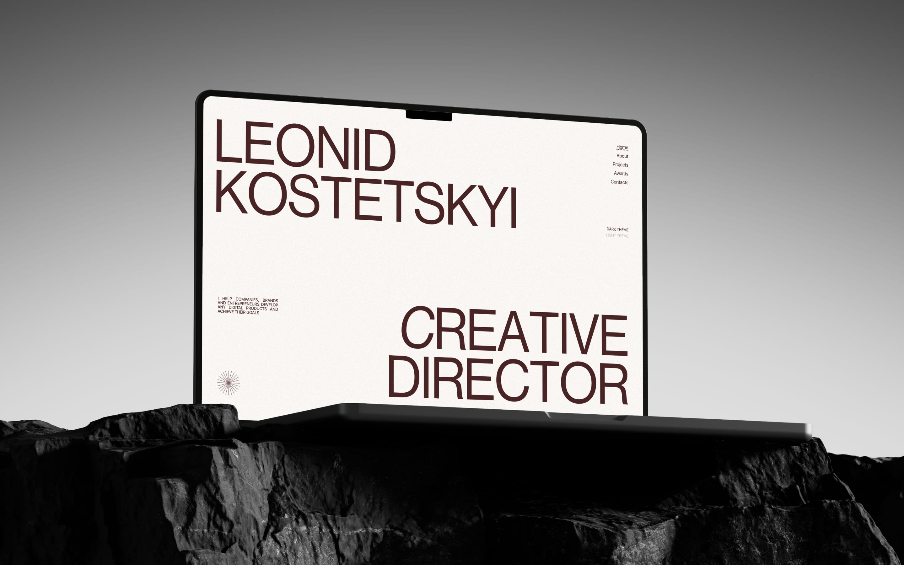 Laptop on black rock showing the portfolio hero with oversized Leonid Kostetskyi and Creative Director type